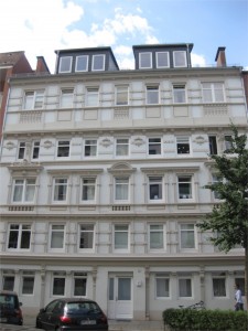 My mother's family had an apartment that is where the first two windows are to the left of the front door at street level.  Only windows at that time were at the back of the building.