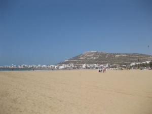 Agadir beach.  The writing on the mountain side says God, Morocco and King