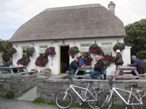 Thatched cafe with tourist bicycles our front.