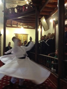 Dervishes accompanied by a small orchestra and male singers chanting texts from the Quran