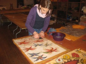 Adding details to the art piece using roving and soapy water