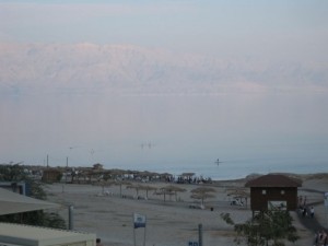 The Dead Sea bathing area with the hazy mountains of Jordan on the other side.  The River Jordan and Dead Sea are the border.