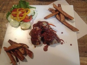 Chicken drizzled in chocolate sauce with sweet potato fries