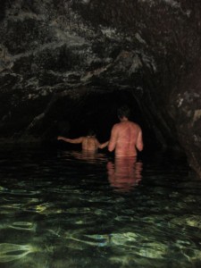 Exploring deeper into the lava tunnel by the light of many head lamps and camera flashes